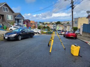 Land surveying equipment set up in a residential neighborhood.